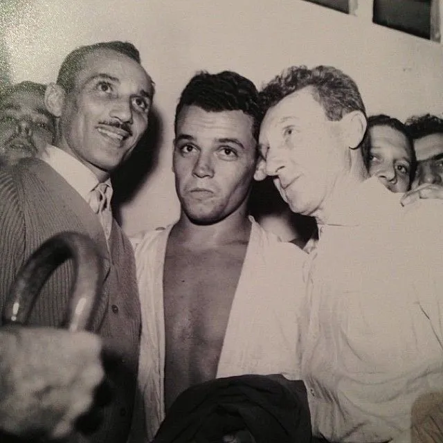 Carlos and Helio Gracie with a fighter after a match
