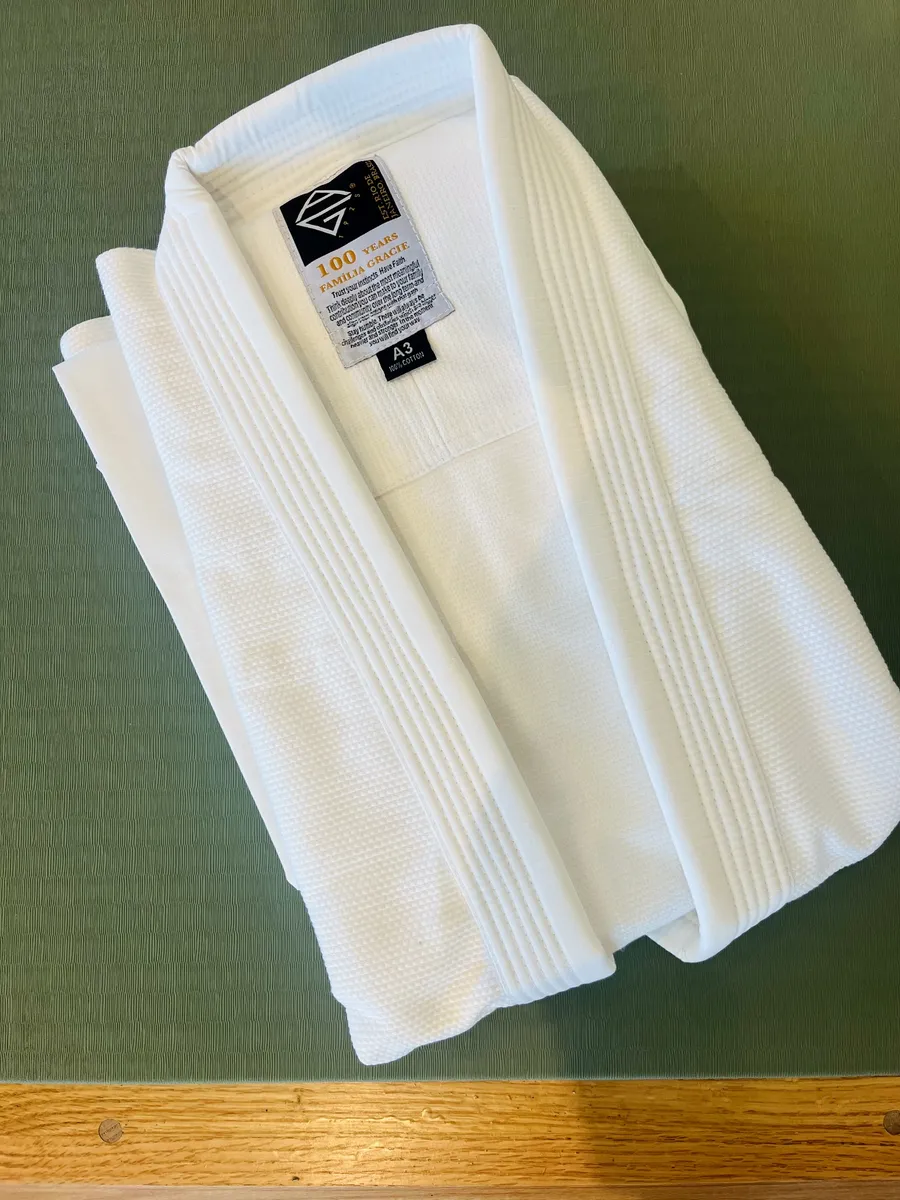 The folded AG1925 kimono, showing its 100 Years Família Gracie label