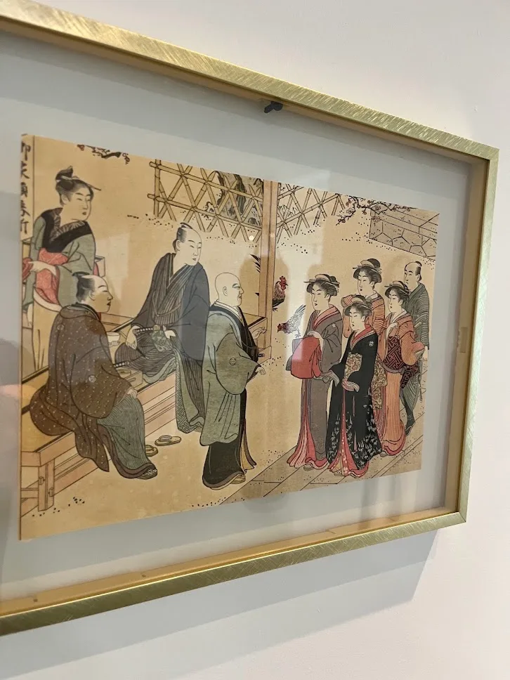 A framed Japanese woodblock print on the academy wall